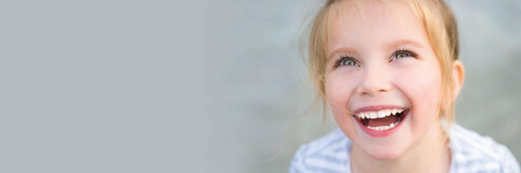 young girl with blonde hair smiling | dentist oakbrook terrace