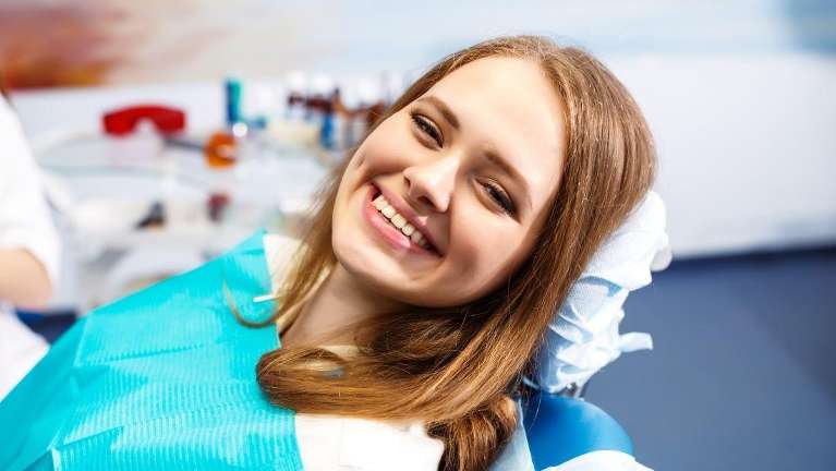 woman smiling in dentist chair | airway dentist near me