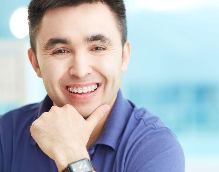 man wearing watch smiling | teeth whitening oakbrook terrace il