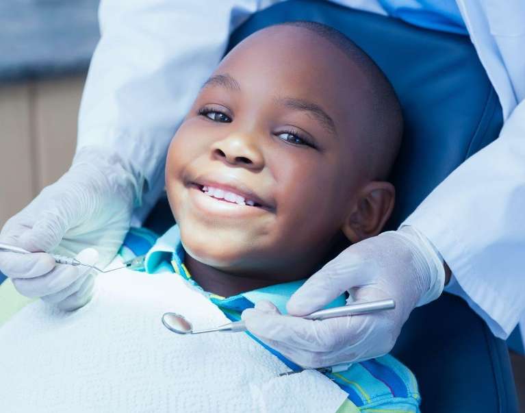 young child sitting in exam chair | childrens dentist oakbrook terrace il