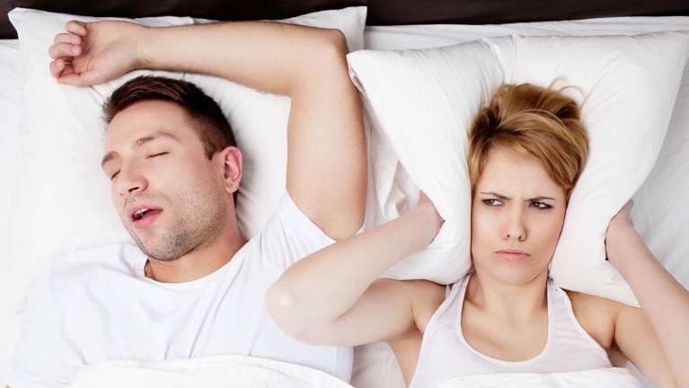 man snoring in bed | airway dentist near me