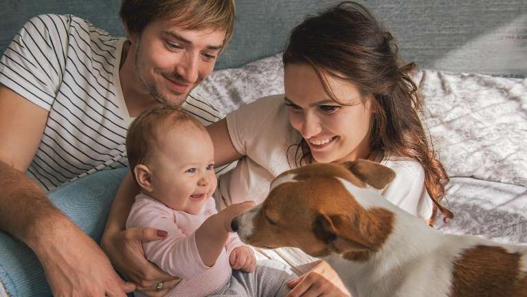 parents with baby smiling | dentist near me