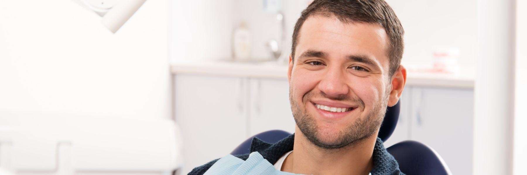 man sitting in dentist exam chair | oakbrook terrace dentist